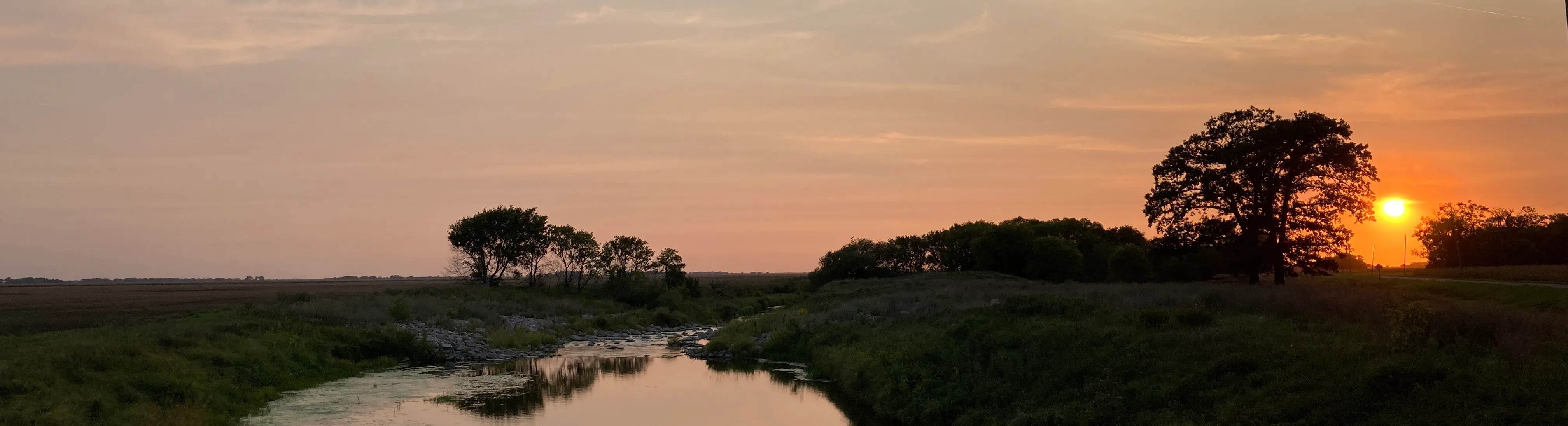 Sunset view of Sand Hill River and surrounding landscape.